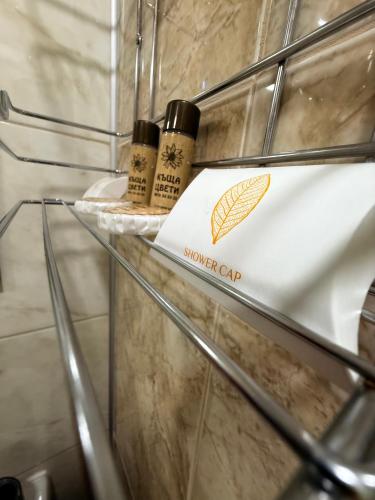 a glass shelf in a bathroom with a towel on it at Къща Цвети in Dobrinishte
