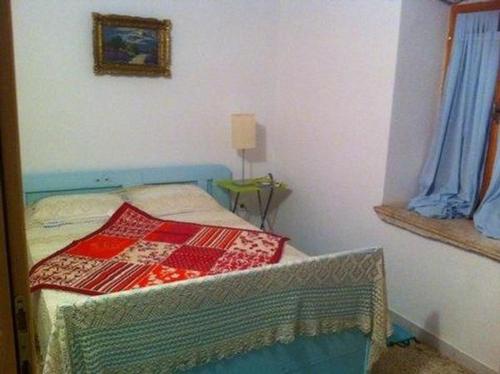 a bedroom with a bed with a quilt on it at 1 Eti And Mia House in Muntić