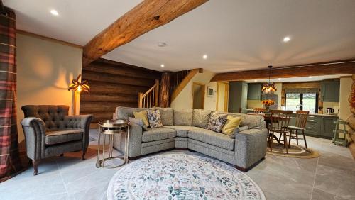 a living room with a couch and two chairs at Lake District Log Cabins in Broughton in Furness