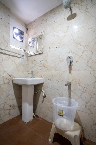 a bathroom with a sink and a toilet at Hotel Vyshak residency in Mysore
