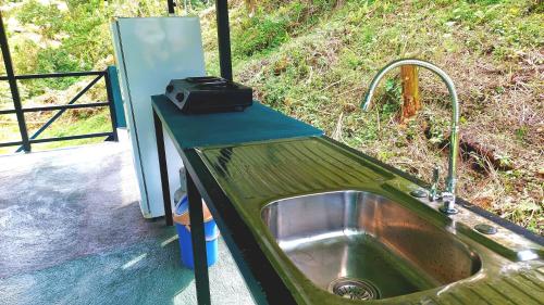 a kitchen with a sink and a grill at Rustico Villa Arenal in Fortuna