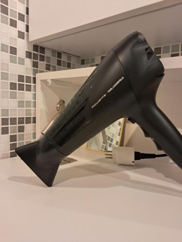 a black hair dryer sitting on a counter in a bathroom at La dimora dalle Mura in Savona