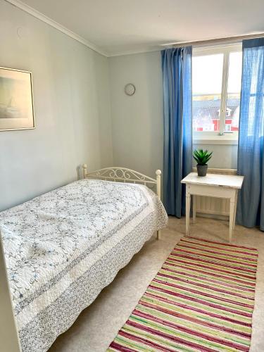a bedroom with a bed and a table and a window at Trollebo Säteri in Vetlanda