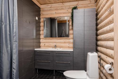 a bathroom with a toilet and a sink at Yyteri Beach Lomakeskus, Havulinna 29 in Pori