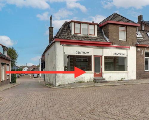 a building with a red arrow in front of it at Room in Lobith in Lobith