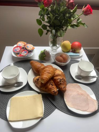 a table with plates of food on a table at Room in Lobith in Lobith