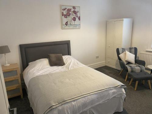 a bedroom with a bed and a chair at Comfortable Norton Studio in Stockton-on-Tees