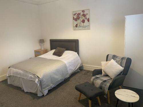 a small bedroom with a bed and a chair at Comfortable Norton Studio in Stockton-on-Tees