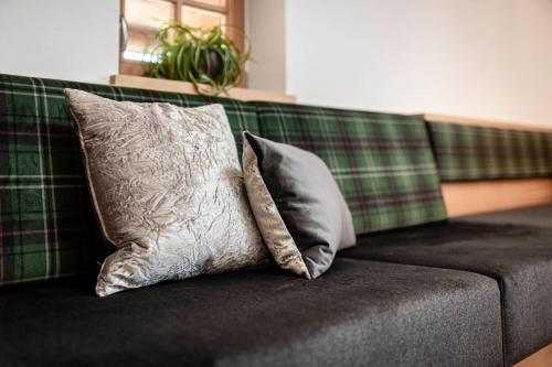 two pillows sitting on top of a couch at Großplonerhof in Luson