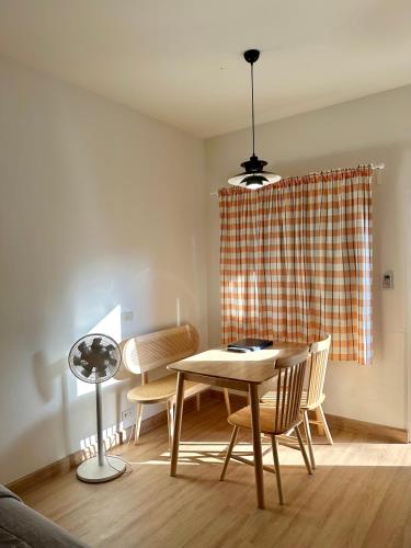 a dining room with a table and chairs at J House in Nonthaburi