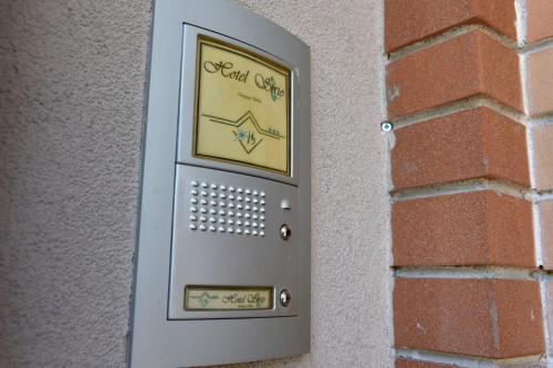 a metal door with a sign on a brick wall at Hotel Sirio in Rotonda
