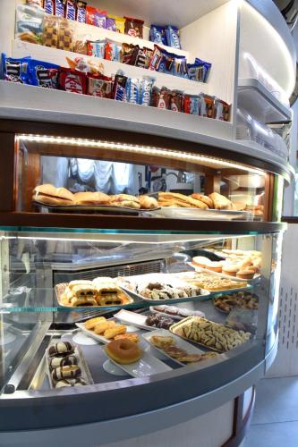 a display case in a bakery with many different pastries at Hotel Sirio in Rotonda