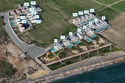 an aerial view of a resort complex next to the water at Serenity Waves Villa 9 in Sophtadhes