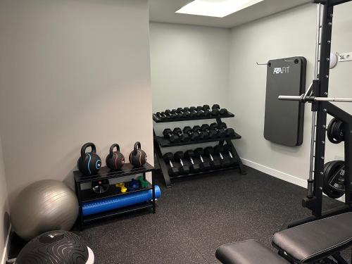 a room with a gym with a rack of weights at M'AR De AR Auria in Lisbon