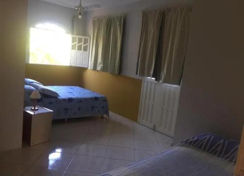 Katil atau katil-katil dalam bilik di Casa com piscina temporada