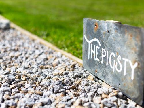 a sign that reads integrity sitting on a pile of rocks at The Sty, rural retreat for couples in Falmouth
