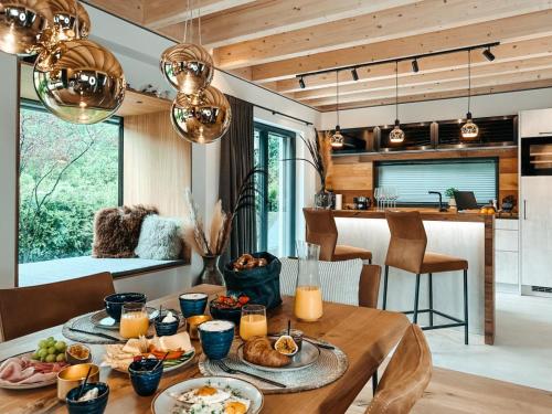 a dining room with a table with food on it at ZSAM Chalets mit Sauna und Hottub in Garmisch-Partenkirchen