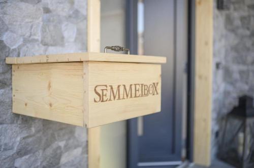 a wooden box with the word sandwich written on it at Wetzstoa Chalet in Unterammergau mit Sauna und Whirlpool in Unterammergau