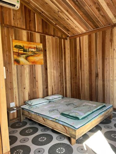 a wooden cabin with a bed in a room at Peaceful Hill Homestay in Ke Ga