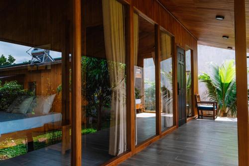 a room with sliding glass doors on a house at An Land Garden Homestay in Buôn Alê (1)