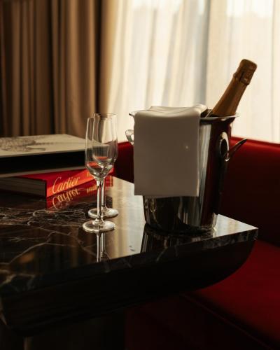 a glass of wine sitting on a table with a coffee maker at Marly Boutique Hôtel in Casablanca
