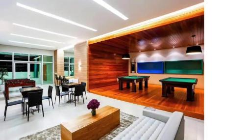 a living room with a couch and tables and chairs at Apartamento no Shopping em Brasília DF in Brasilia