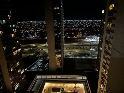 a view of a city at night from a building at Apartamento no Shopping em Brasília DF in Brasilia