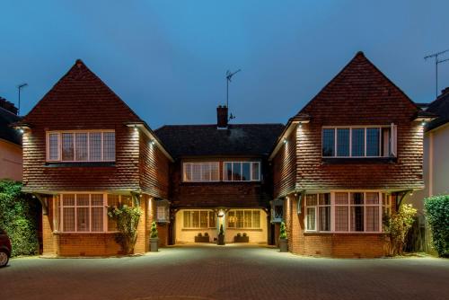 a large brick house with a driveway at Martel Guest House in London
