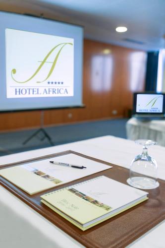 a table with a sign for the hotel africa at El Mouradi Hotel Africa Tunis in Tunis