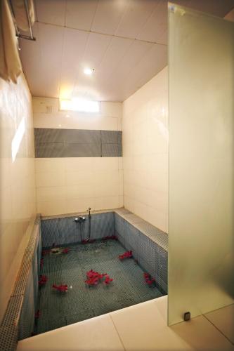 a room with a shower with red flowers in it at CABANA- 5 BHK Luxury Villa near Udaipur in Dabok