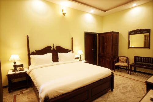 a bedroom with a large bed and a mirror at CABANA- 5 BHK Luxury Villa near Udaipur in Dabok