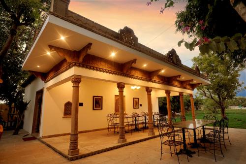 a patio with a table and chairs on it at CABANA- 5 BHK Luxury Villa near Udaipur in Dabok
