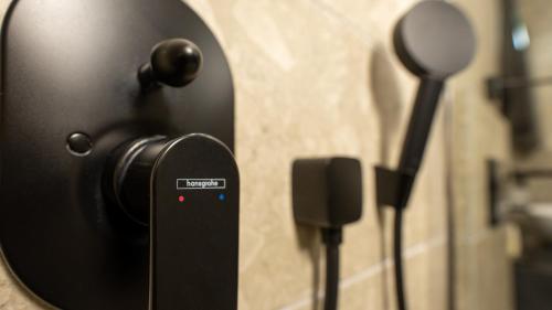 a bathroom door with a mirror and a speaker at CLOUD 5 Blloku Rooms Tirana in Tirana