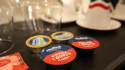 a group of containers of coffee sitting on a table at CLOUD 5 Blloku Rooms Tirana in Tirana
