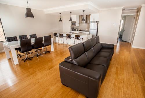 a living room with a couch and a kitchen at Neagles Retreat Villas in Clare