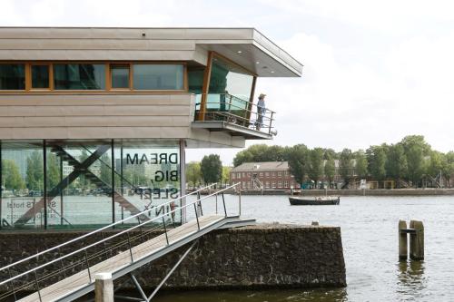a building on the water next to a body of water at SWEETS - Oosterdoksdraaibrug in Amsterdam