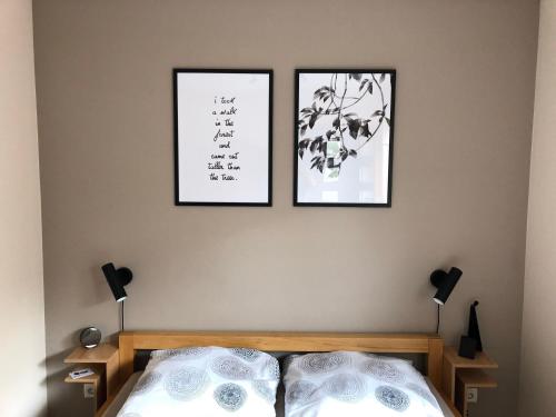 a bedroom with two pictures on the wall and a bed at Fewo 5 Jahreszeiten in Bell