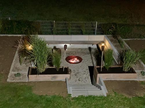 an outdoor garden at night with a fire pit at Fewo 5 Jahreszeiten in Bell