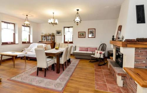 a living room with a table and a fireplace at Ferienhaus Sofija in Vrtlinovec