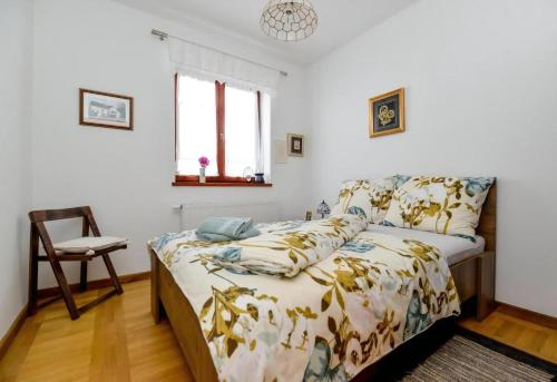 a bedroom with a bed and a chair at Ferienhaus Sofija in Vrtlinovec