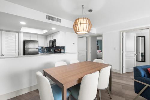 a kitchen and dining room with a wooden table and chairs at Compass Cove in Myrtle Beach