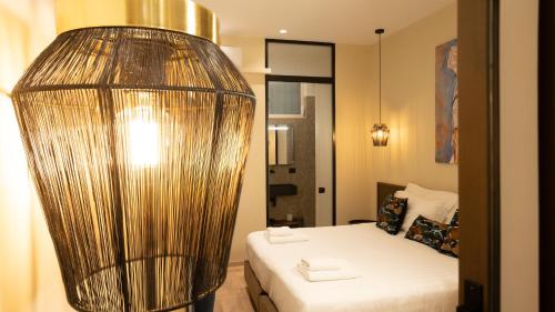 a hotel room with a bed and a large lamp at CLOUD 5 Blloku Rooms Tirana in Tirana