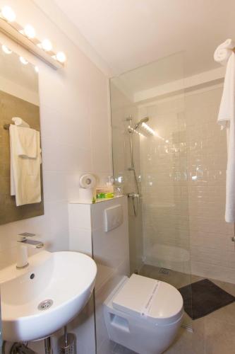 a bathroom with a sink and a toilet and a shower at B&B Vibe in Split