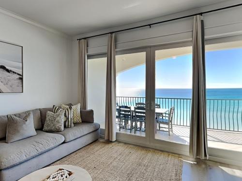 a living room with a couch and a view of the ocean at Adagio #403B in Santa Rosa Beach