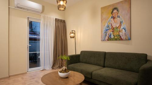 a living room with a couch and a painting on the wall at CLOUD 5 Blloku Rooms Tirana in Tirana