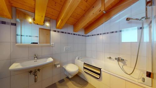 a bathroom with a sink and a toilet and a shower at Perce Neige SUBLIME & VIEW apartments by Alpvision Résidences in Veysonnaz