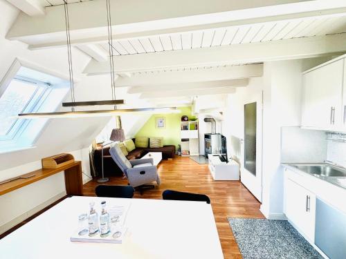 a kitchen and living room with a table and chairs at Ginsterweg 1a in Wyk auf Föhr