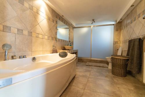 a bathroom with a tub and a toilet and a sink at Great property - amazing views in Limassol