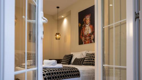 a living room with a couch and a painting at CLOUD 5 Blloku Rooms Tirana in Tirana