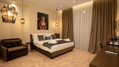 a hotel room with a bed and a chair at CLOUD 5 Blloku Rooms Tirana in Tirana